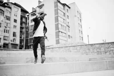 Portrait of jumping stylish african american man on sportswear,