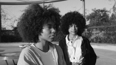 portrait of two mixed race black women in the park at sunrise